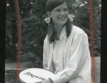Sally Ride '72 wearing pigtails and holding a tennis racquet